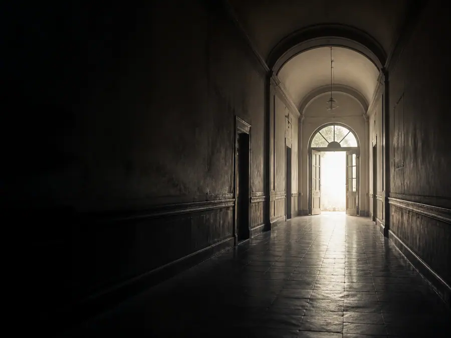 Soft daylight at the end of a quiet historic corridor